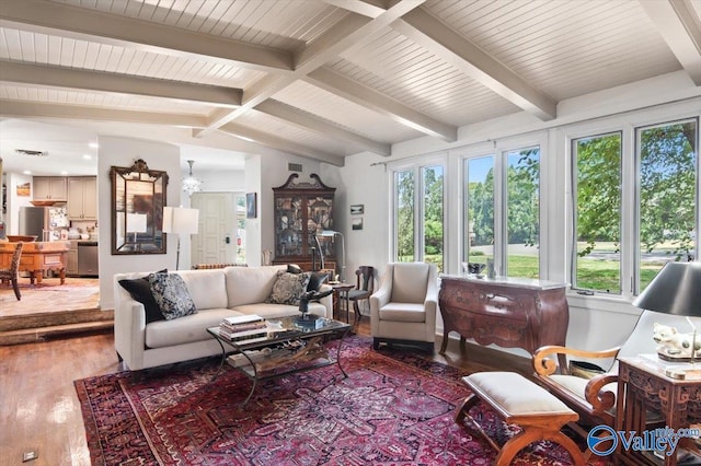 sunroom with lofted ceiling with beams