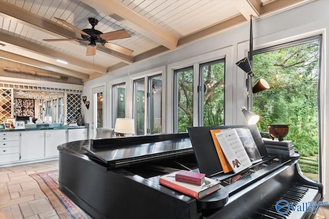 interior space with ceiling fan, wooden ceiling, and vaulted ceiling with beams