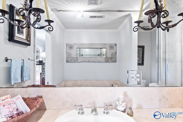 bathroom with crown molding, toilet, a chandelier, and sink