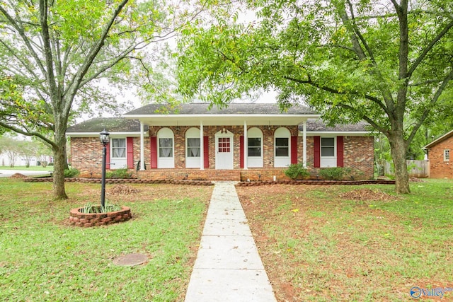 ranch-style house featuring a porch and a front lawn