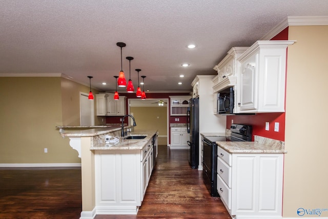 kitchen with dark wood-type flooring, white cabinets, black appliances, sink, and pendant lighting