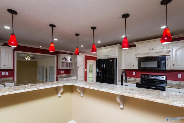 kitchen with ornamental molding, black appliances, and white cabinets