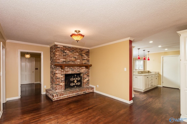 unfurnished living room featuring ornamental molding, a textured ceiling, dark hardwood / wood-style floors, and a fireplace