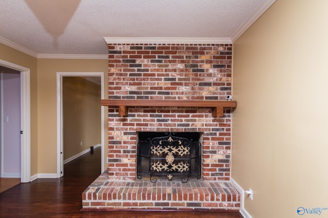 room details with a fireplace, wood-type flooring, ornamental molding, and a textured ceiling