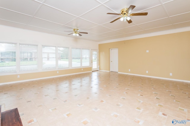 unfurnished room with a paneled ceiling and ceiling fan