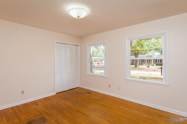 empty room with hardwood / wood-style flooring