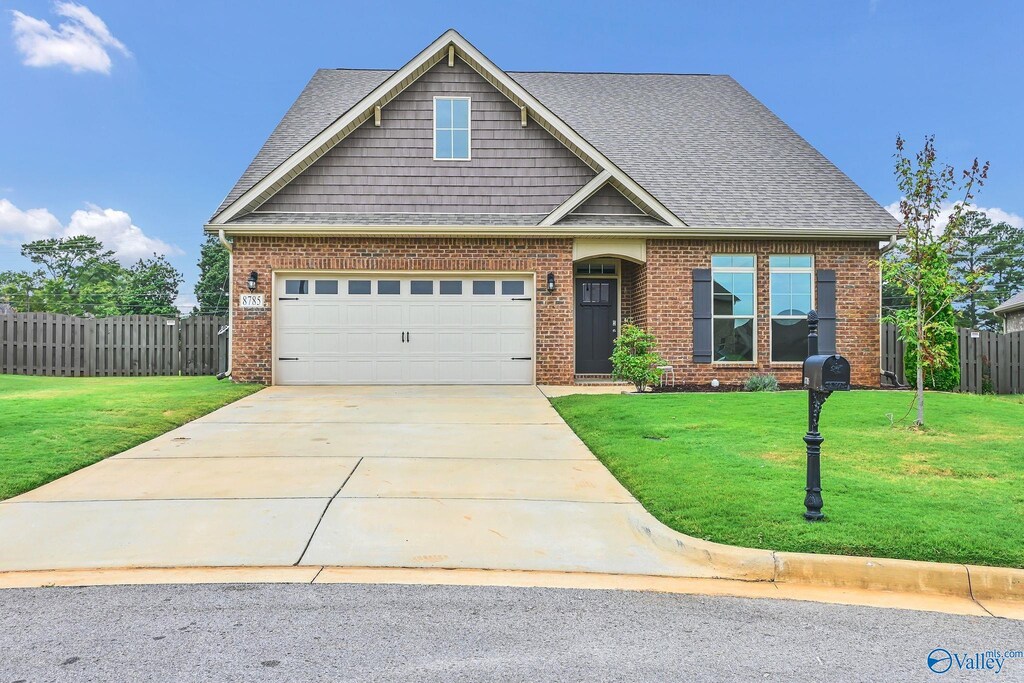 view of front of house with a front yard and a garage