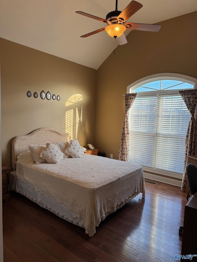 bedroom featuring ceiling fan, dark hardwood / wood-style flooring, and vaulted ceiling