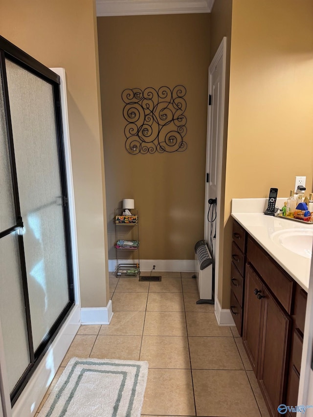 bathroom with tile patterned flooring, vanity, and crown molding