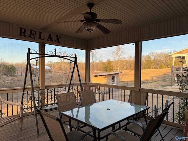 wooden deck featuring an outbuilding and ceiling fan