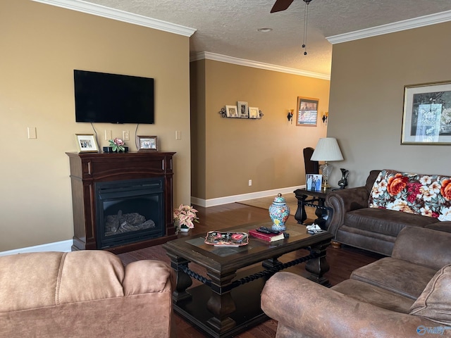 living room featuring ceiling fan, dark wood-type flooring, ornamental molding, and a textured ceiling