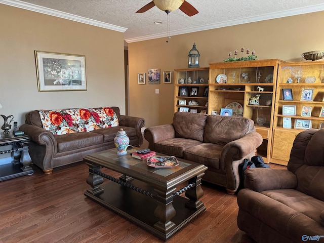 living room featuring dark hardwood / wood-style flooring, ornamental molding, ceiling fan, and a textured ceiling