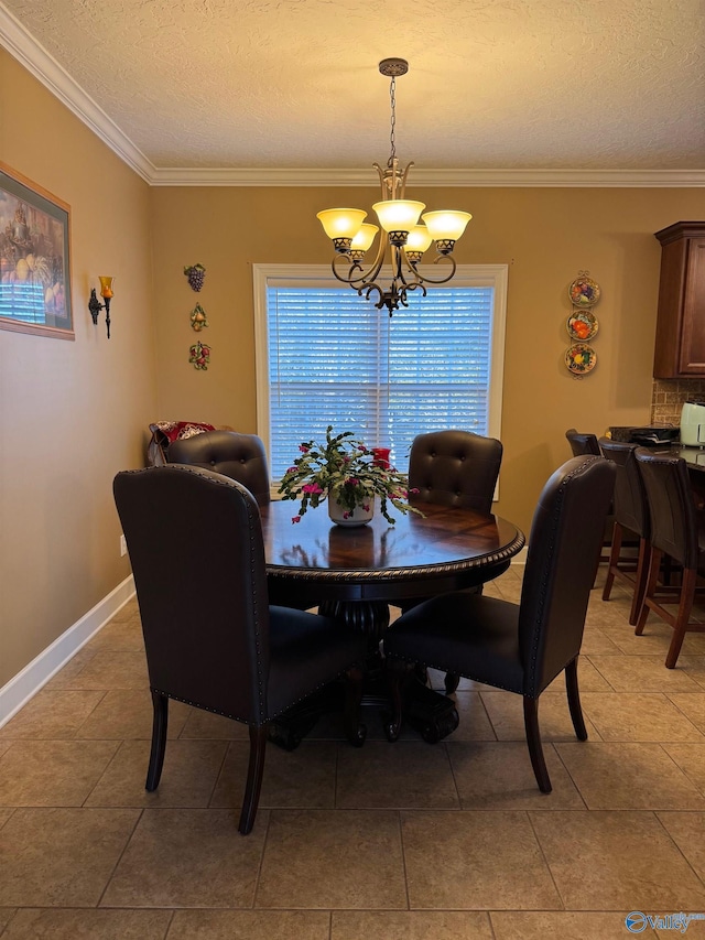 dining area with light tile patterned flooring, ornamental molding, a chandelier, and a textured ceiling