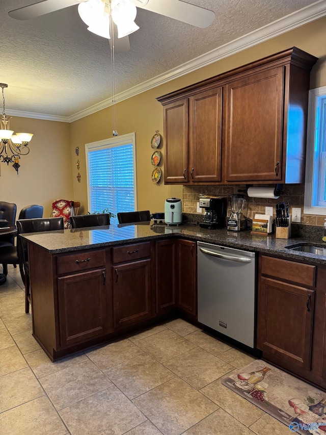 kitchen with sink, stainless steel dishwasher, a textured ceiling, and kitchen peninsula