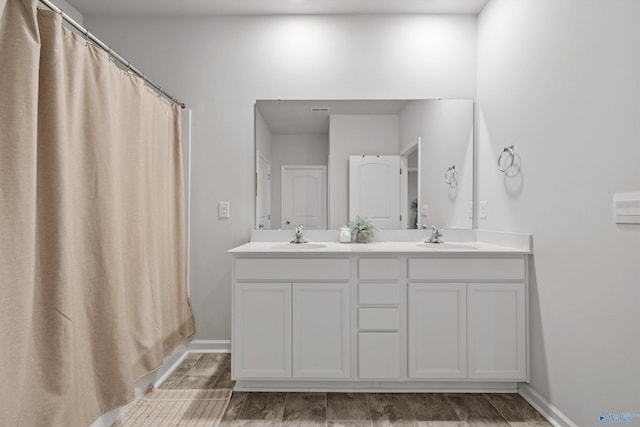 25066 Delilah Cir, Athens, AL 35613 - full bathroom with baseboards, wood finished floors, a sink, and double vanity
