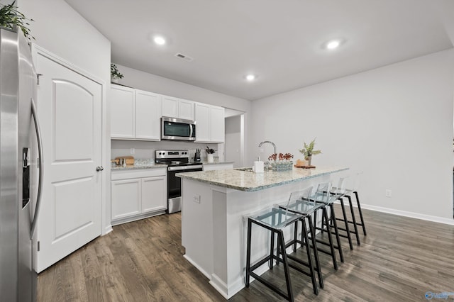 25066 Delilah Cir, Athens, AL 35613 - kitchen with a sink, a kitchen island with sink, dark wood finished floors, appliances with stainless steel finishes, and visible vents