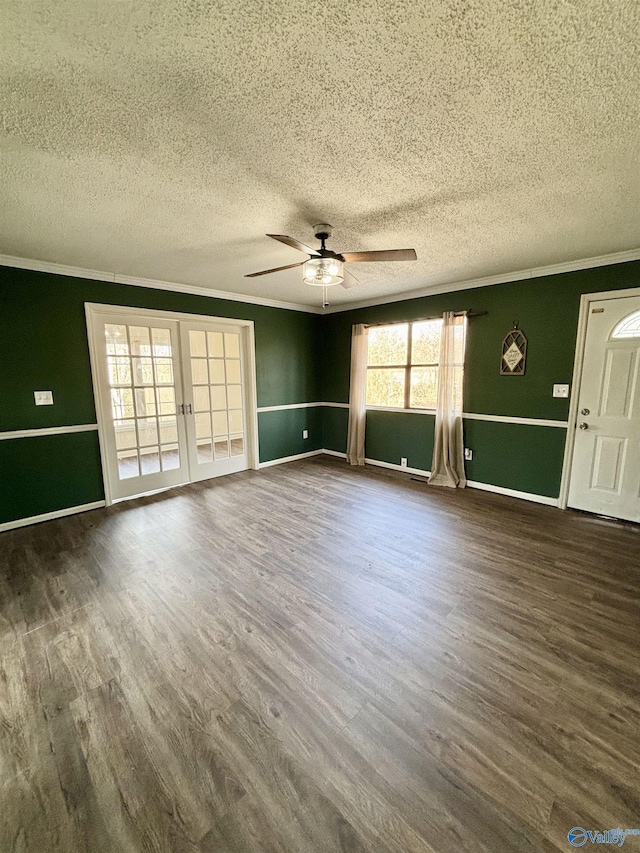 unfurnished living room with french doors, ceiling fan, ornamental molding, and dark wood-type flooring