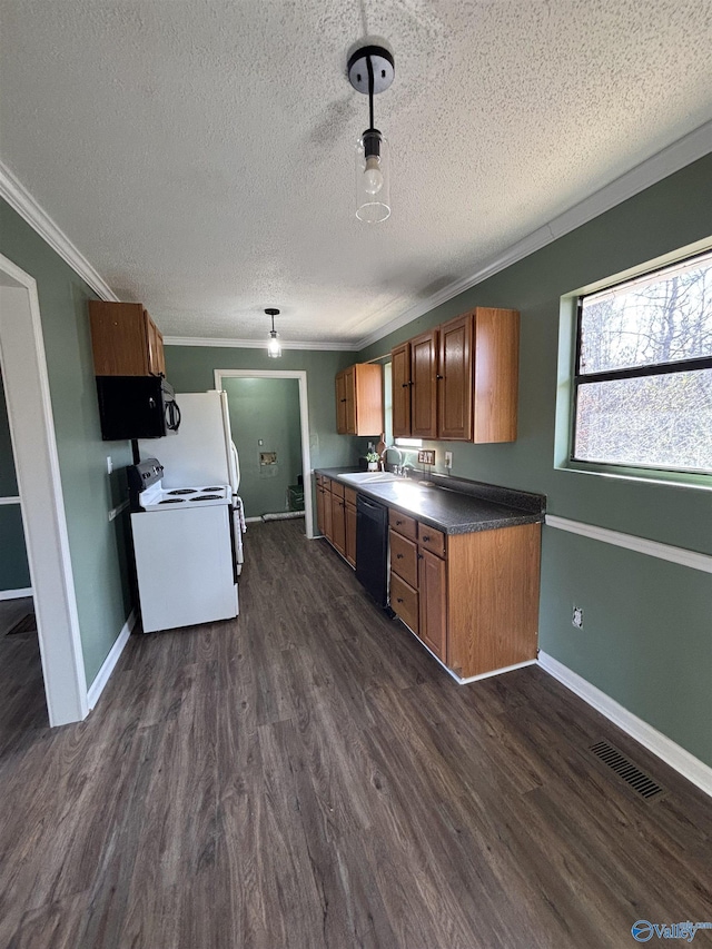 kitchen with sink, dark hardwood / wood-style floors, ornamental molding, black appliances, and a textured ceiling