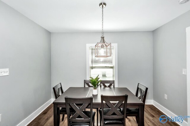 dining area featuring baseboards and dark wood-style floors