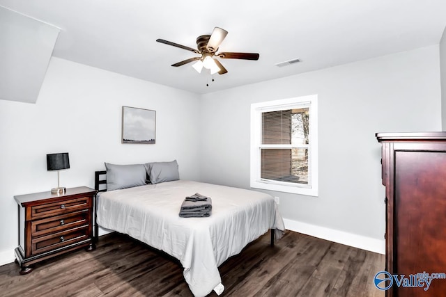bedroom featuring visible vents, a ceiling fan, baseboards, and dark wood-style flooring