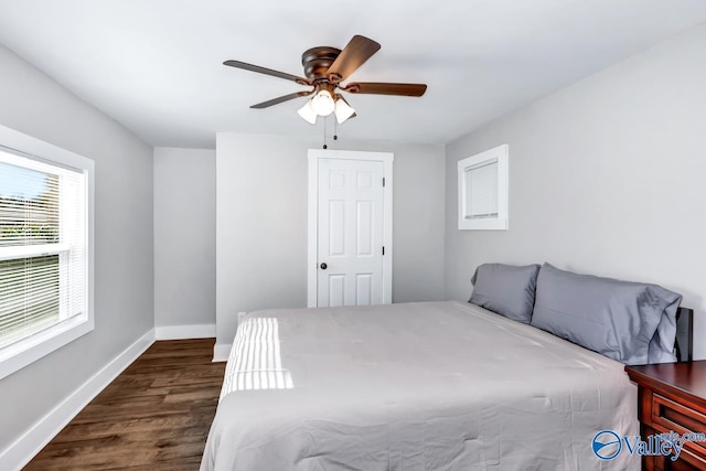 bedroom featuring baseboards, ceiling fan, and dark wood-style flooring