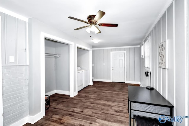 unfurnished bedroom with washer and clothes dryer, a ceiling fan, dark wood-type flooring, baseboards, and two closets