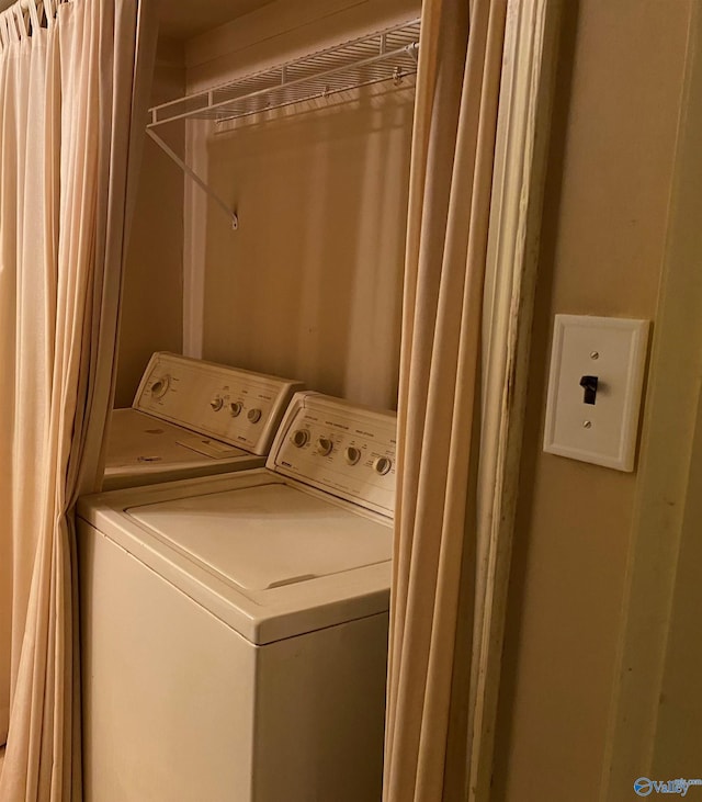 washroom with separate washer and dryer and laundry area