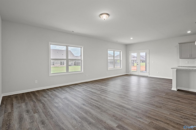 unfurnished living room with dark hardwood / wood-style flooring