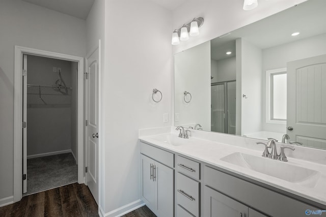 bathroom featuring vanity, wood-type flooring, and an enclosed shower