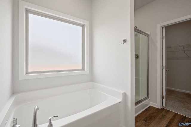 bathroom with hardwood / wood-style floors and plus walk in shower