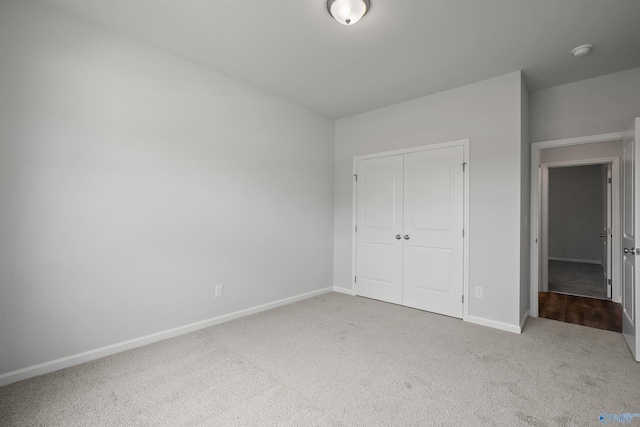 unfurnished bedroom with carpet and a closet