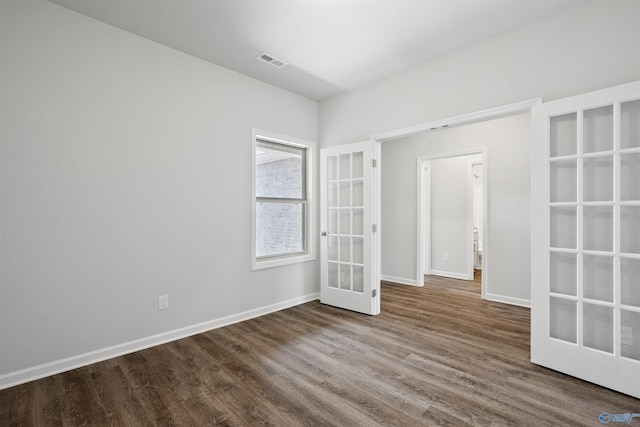 empty room with wood-type flooring and french doors