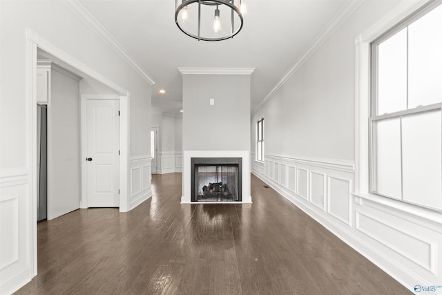 unfurnished living room featuring ornamental molding and dark hardwood / wood-style flooring