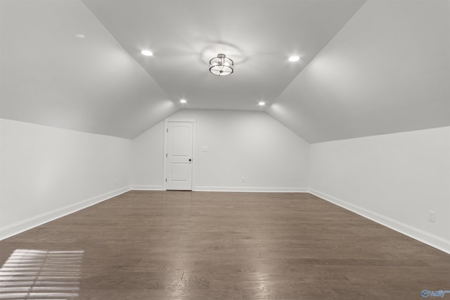 bonus room with dark wood-type flooring and lofted ceiling