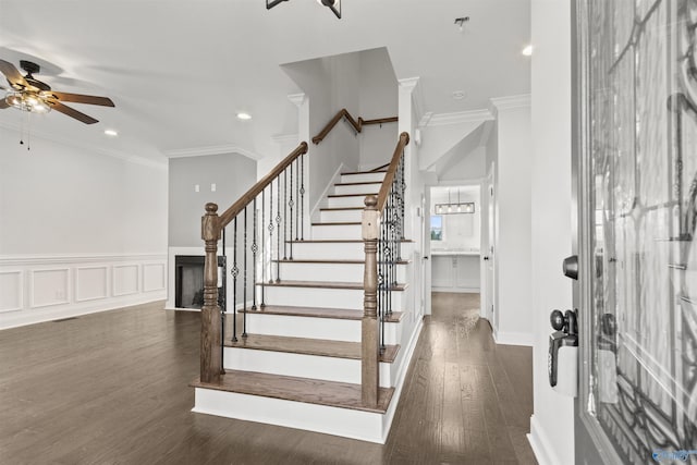 foyer entrance featuring ceiling fan, ornamental molding, and dark hardwood / wood-style floors