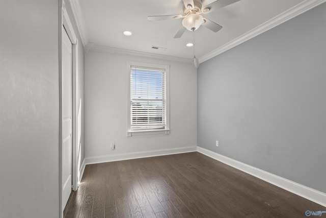 empty room with ceiling fan, dark hardwood / wood-style floors, and ornamental molding