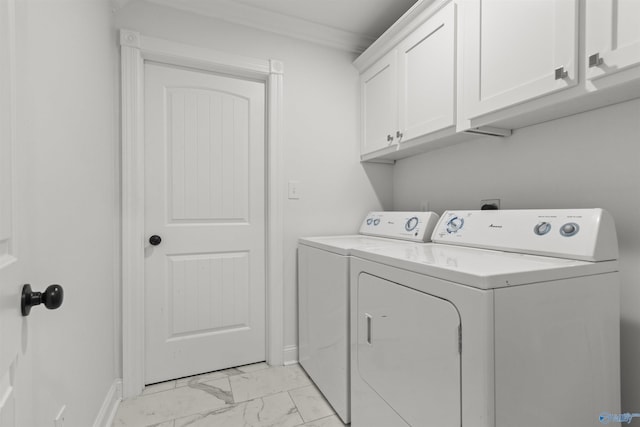 washroom with crown molding, cabinets, and washer and dryer