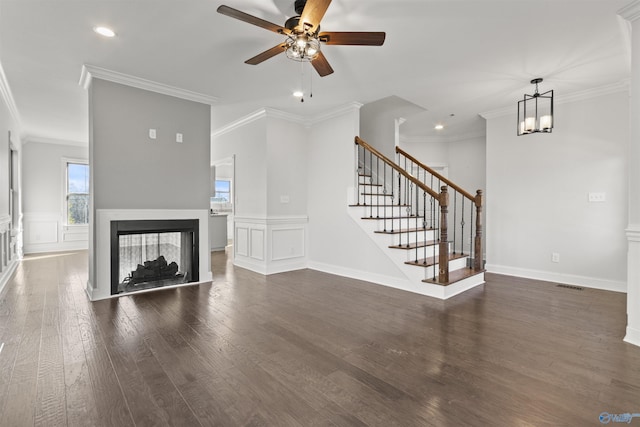 unfurnished living room with crown molding, a multi sided fireplace, ceiling fan, and dark hardwood / wood-style flooring