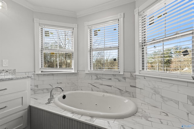 bathroom featuring a tub, plenty of natural light, vanity, and ornamental molding