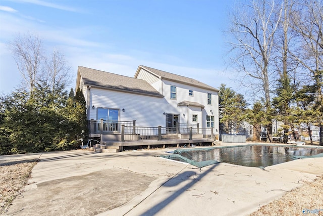 rear view of house featuring a patio area and a swimming pool side deck