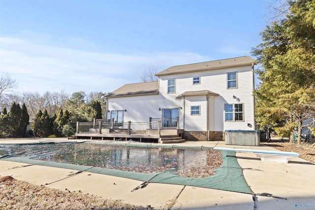 exterior space with a diving board and a wooden deck