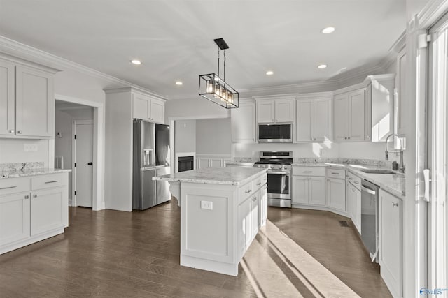 kitchen featuring sink, white cabinetry, stainless steel appliances, and a kitchen island