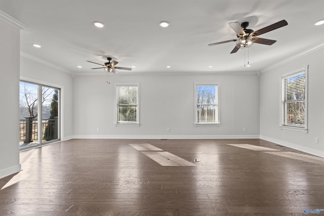 spare room featuring plenty of natural light, dark hardwood / wood-style floors, and crown molding