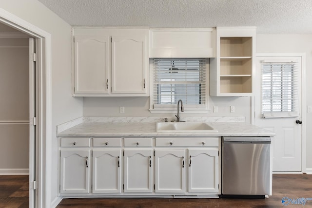 kitchen featuring dark wood-type flooring, a sink, a textured ceiling, white cabinets, and dishwasher