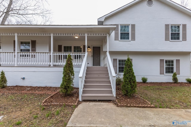 tri-level home with stairway and a porch