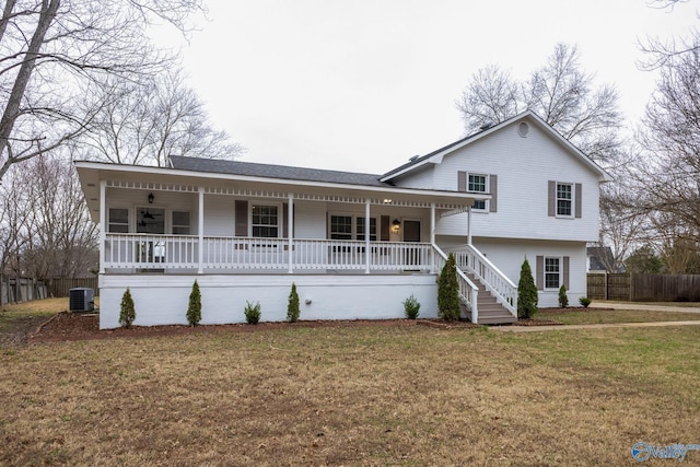 split level home featuring a front lawn, covered porch, and central AC unit