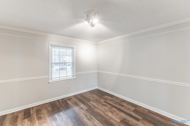 empty room featuring a textured ceiling, dark hardwood / wood-style flooring, and ornamental molding