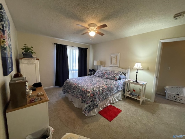 carpeted bedroom with a textured ceiling and ceiling fan