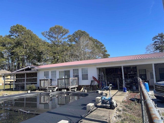 rear view of house featuring a deck