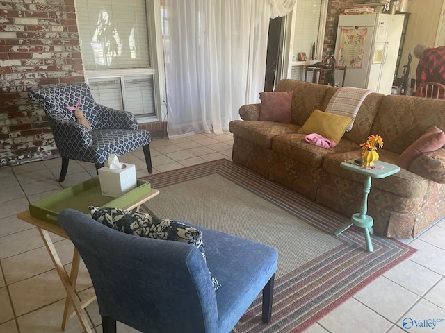 living room with brick wall and light tile patterned floors